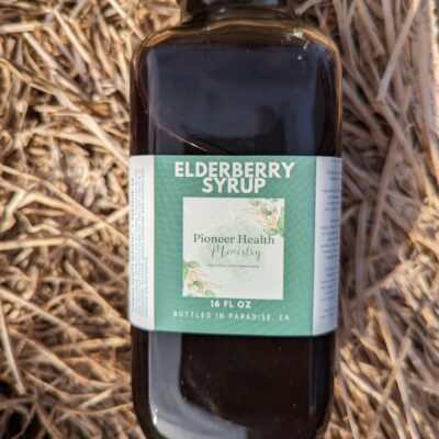 elderberry syrup in bottle on hay