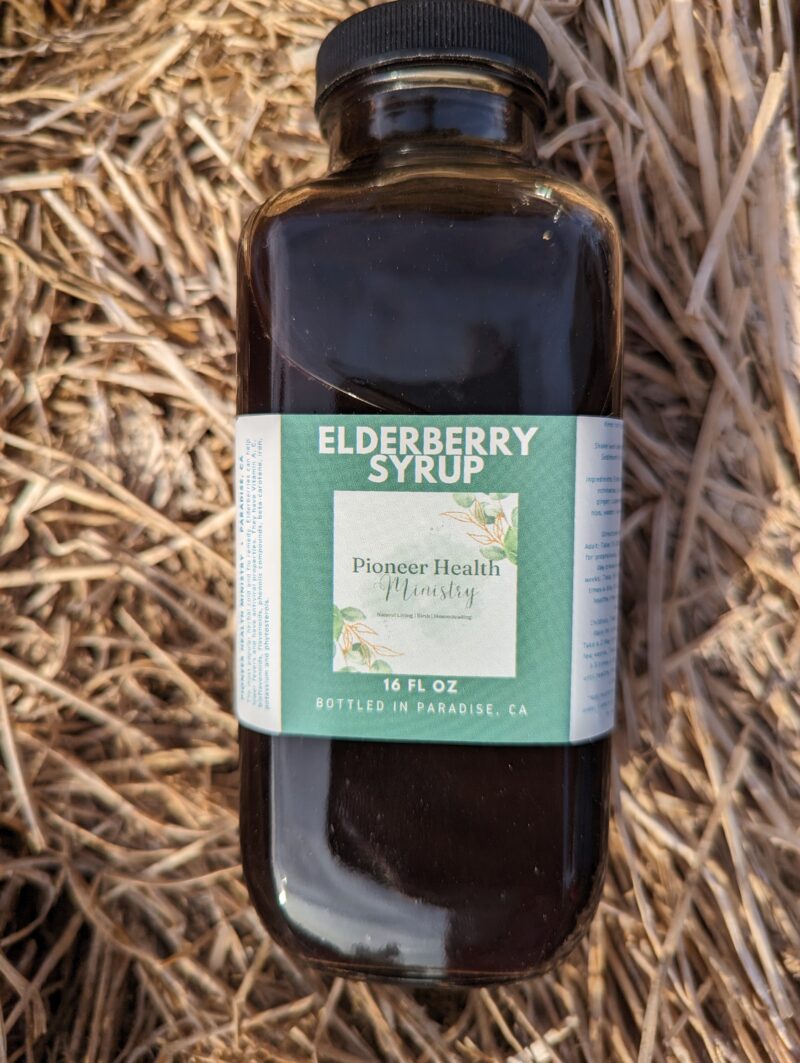 elderberry syrup in bottle on hay